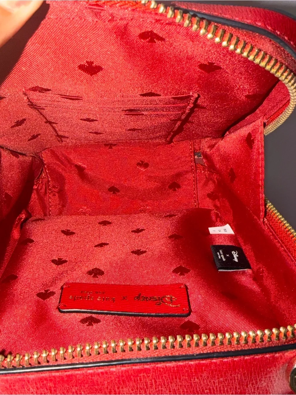kate spade red and cream Cruella-themed crossbody bag